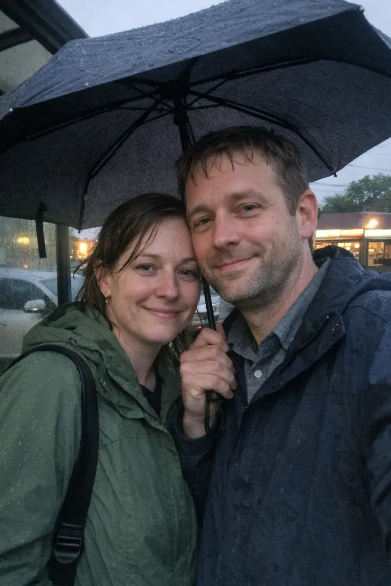 Candid rainy city photo of a couple under an umbrella